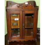 An oak smokers cabinet with glazed doors and a set of postal scales (weights lacking)