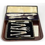 A cased silver-plated set of nutcrackers, picks and grape scissors, by Manoah Rhodes & Son Ltd;