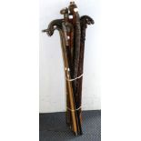 An ebonised walking cane with an Indian white metal handle stamped 925, together with two silver