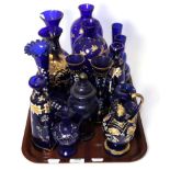 A tray of decorative gilt and enamelled blue glass including jugs and vases