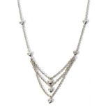 An 18 carat white gold diamond necklace, the front with three trace chain strands each suspending