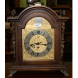 A modern bracket clock with arched dial inscribed Tempus Fugit