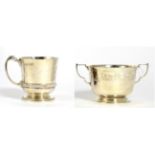 A silver twin-handled Christening cup, by the Goldsmiths & Silversmiths Company, London 1934 with