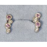 A Pair of 18 carat white gold pink sapphire and diamond earrings, a bar of two round cut pink