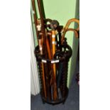 A collection of walking sticks in a stick stand