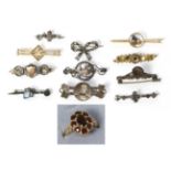 A 9 carat gold brooch, two brooches stamped '15ct' and '15c', a 9 carat gold dress ring and other