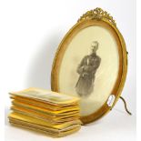 A gilt oval photograph frame depicting an officer, together with a quantity of stereo cards