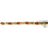 A 9 carat gold amber bracelet, five oval cabochon amber in rubbed over settings, spaced by pierced