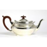 A silver teapot, Birmingham 1928, oval with gadroon rim, 28cm long handle to spout, 19.5ozt