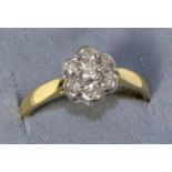 An 18 carat gold diamond cluster ring, total estimated diamond weight 0.55 carat approximately,