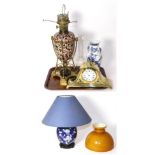 Brass and Imari style pottery oil lamp; a Chinese blue and white vase; brass mantel clock; and a