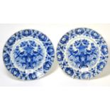 A Pair of Dutch Delft Plates, early 18th century, painted in blue with a basket of flowers on a