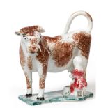 A Pearlware Cow Creamer, circa 1820, the standing beast with brown sponged markings, a milkmaid