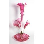 A Cranberry Glass Epergne, the central trumpet vase flanked by three further vases, on a fluted