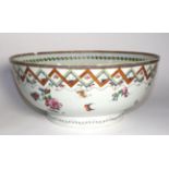 A Chinese Porcelain Punch Bowl, Qianlong, painted in famille rose enamels with flowersprays within