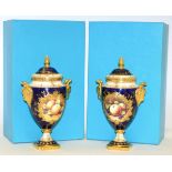 A Pair of Coalport Porcelain Urn Shaped Vases and Covers, 20th century, decorated with still lives