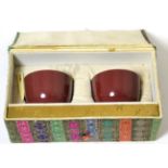A Pair of Chinese Sang de Boeuf Glazed Tea Bowls, Qing Dynasty, 6cm diameter, in presentation box