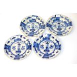 A Set of Four Delft Plates, early 18th century, painted in blue in Kangxi style with a basket of