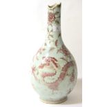 A Chinese Porcelain Bottle Vase, probably 18th century, painted in underglaze red with a dragon