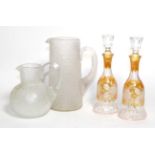 A Pair of Amber Overlay Clear Glass Scent Bottles and Stoppers, early 20th century, engraved with