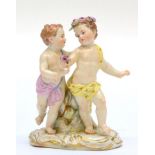 A Meissen Porcelain Figure Group, late 19th century, as a pair of children dancing, on a scroll