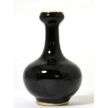 A Chinese Black Glazed Bottle Vase, Qing Dynasty, with garlic neck, 13.5cm high