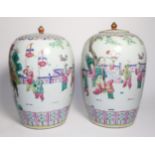 A Pair of Chinese Porcelain Jars and Covers, late 19th century, of ovoid form, painted in famille