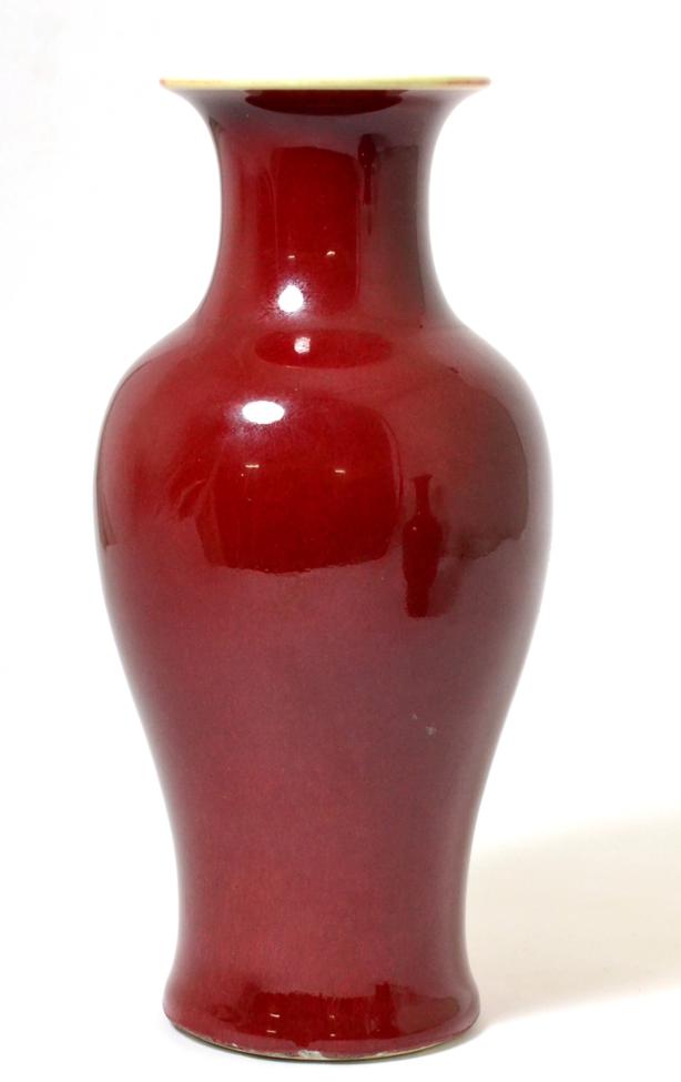 A Chinese Sang de Boeuf Glazed Baluster Vase, Qing Dynasty, with flared neck, 24.5cm high