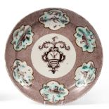 A Savona Faience Circular Dish, 18th century, painted in manganese with an armorial on a powdered