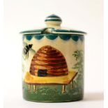 A Wemyss Pottery Small Honey Pot, early 20th century, of cylindrical form, painted with bees and a