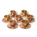 A Matched Set of Seven Royal Worcester Porcelain Miniature Coffee Cups and Saucers, painted by