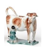 A Pearlware Cow Creamer and Stopper, early 19th century, the standing beast with brown sponged