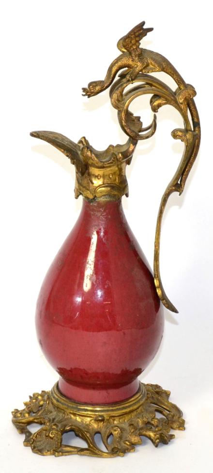 A Gilt Bronze Mounted Chinese Sang de Boeuf Ewer, of baluster form the scroll handle with griffin