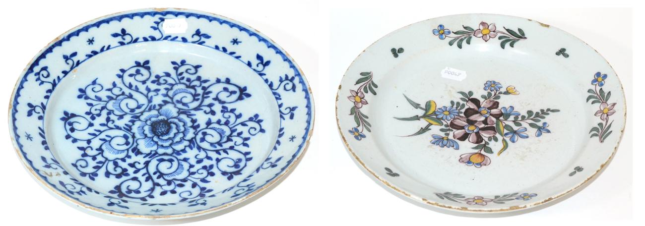 An English Delft Charger, mid 18th century, painted in colours with a central flowerspray and