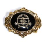 A Victorian Onyx and Seed Pearl Mourning Brooch, an oval onyx plaque with an applied seed pearl