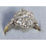 A Diamond Cluster Ring, seven round brilliant cut diamonds in claw settings, to forked diamond set