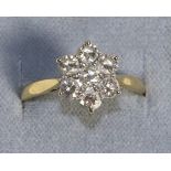 An 18 Carat Gold Diamond Cluster Ring, seven round brilliant cut diamonds in claw settings, to knife