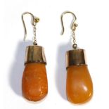 A Pair of Amber Earrings, amber drops to rose coloured mounts, suspended from chains to hook