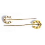 A Diamond Horse Shoe Stick Pin, star set with graduated old cut diamonds, total estimated diamond