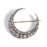 A Diamond Crescent Brooch, two rows of graduated old cut diamonds, total estimated diamond weight