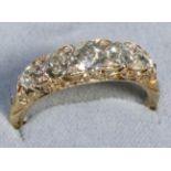 A Diamond Five Stone Ring, graduated old cut diamonds with single-cut diamond accents, to a carved