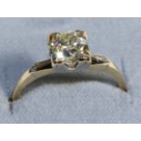 A Solitaire Diamond Ring, an old cut diamond in a square claw setting, to diamond set knife edge