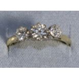 A Three Stone Diamond Ring, graduated old cut diamonds in claw settings, to knife edge shoulders,