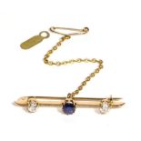 A Sapphire and Diamond Bar Brooch, a round cut sapphire to a knife edge bar terminating in two old