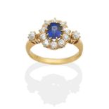 A Sapphire and Diamond Cluster Ring, an oval cut sapphire in a claw setting within a border of old