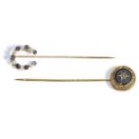 A Sapphire and Seed Pearl Horseshoe Stick Pin, formed of alternating round cut sapphires and seed