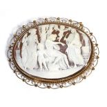 A 9 Carat Gold Cameo Brooch, carved depicting Apollo with attendants and putti, in a rope and scroll