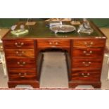 A George III Style Mahogany Partners' Desk, late 19th/early 20th century, with a green and gilt