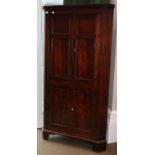 A Regency Mahogany and Ebony Strung Free-Standing Corner Cupboard, early 19th century, with a