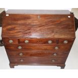 A George III Mahogany Bureau, early 19th century, the fall enclosing a fitted interior of pigeon